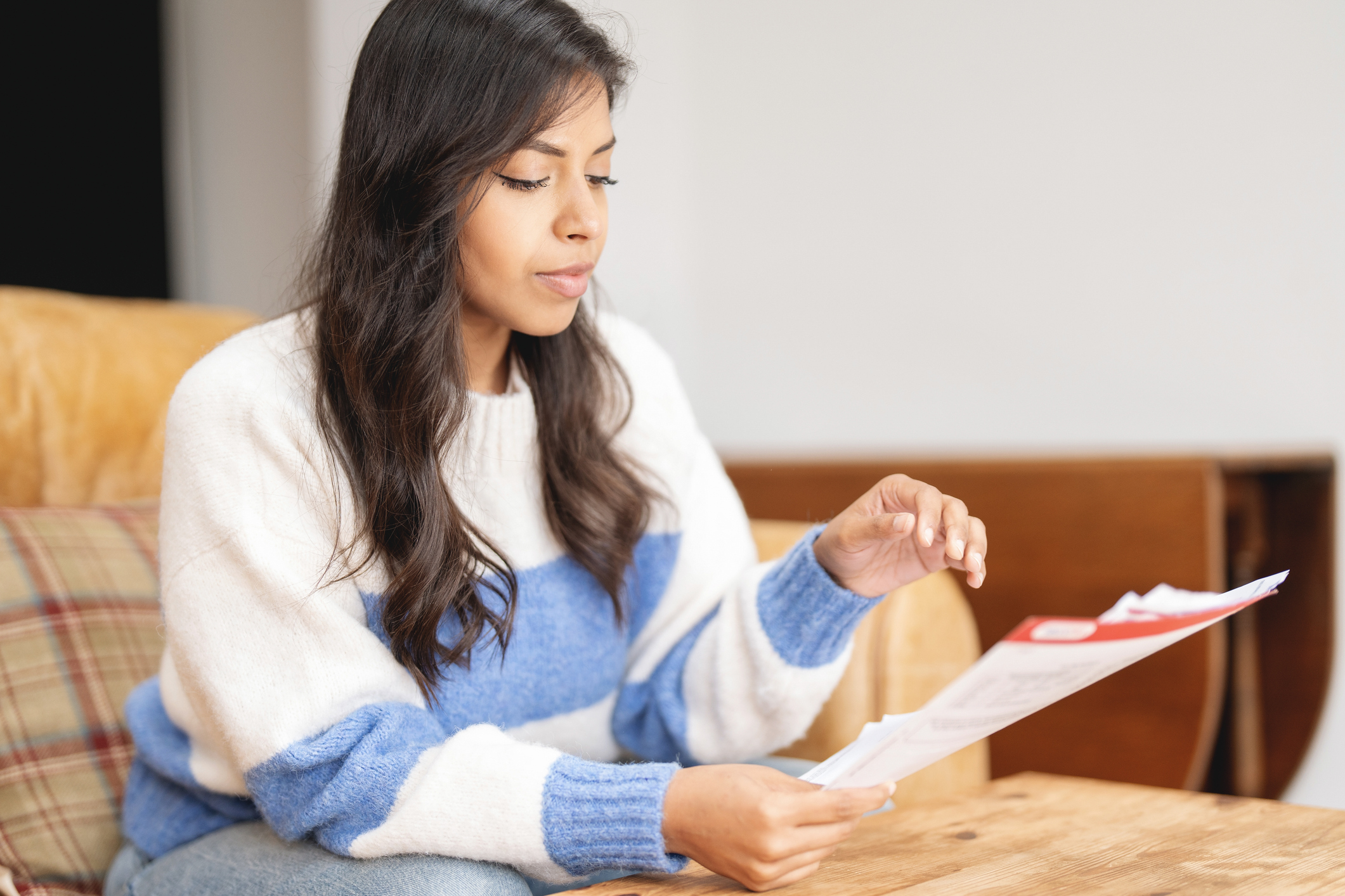 A person reading the information leaflet that comes with their medication