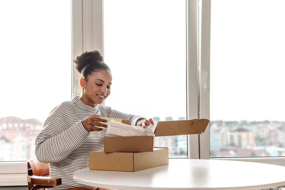 A person opening their medication delivery at home